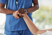 Doctor holding a patient's hand.