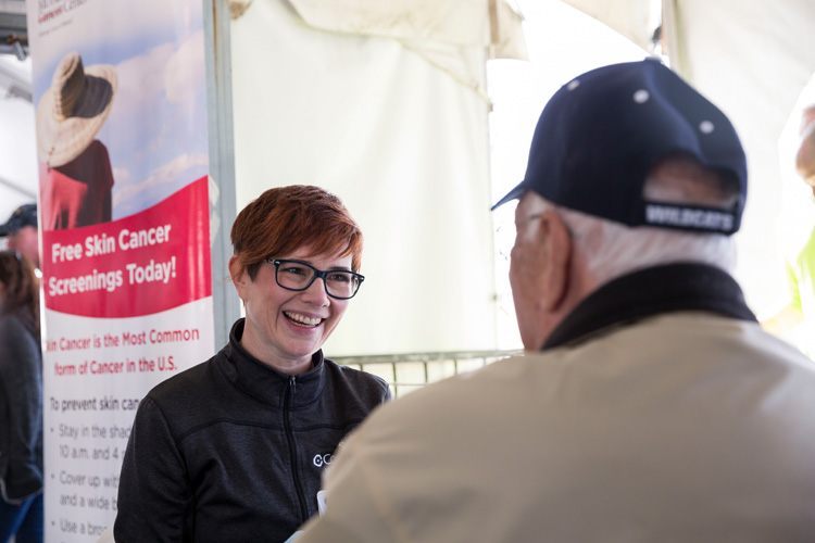 Molly Hammond, Cooper APN, performs a health screening during the HeroCare Connect 2019 Fall Fest for local veterans, active military and first responders.