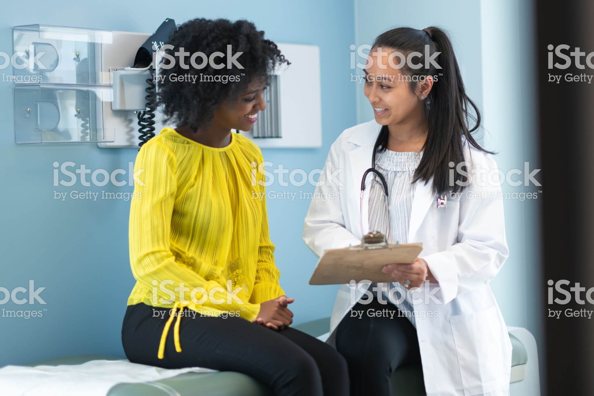 Female doctor speaking with female patient.