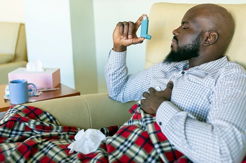 Woman using an inhaler.