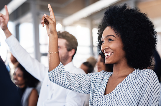 A group of people raising their hands.