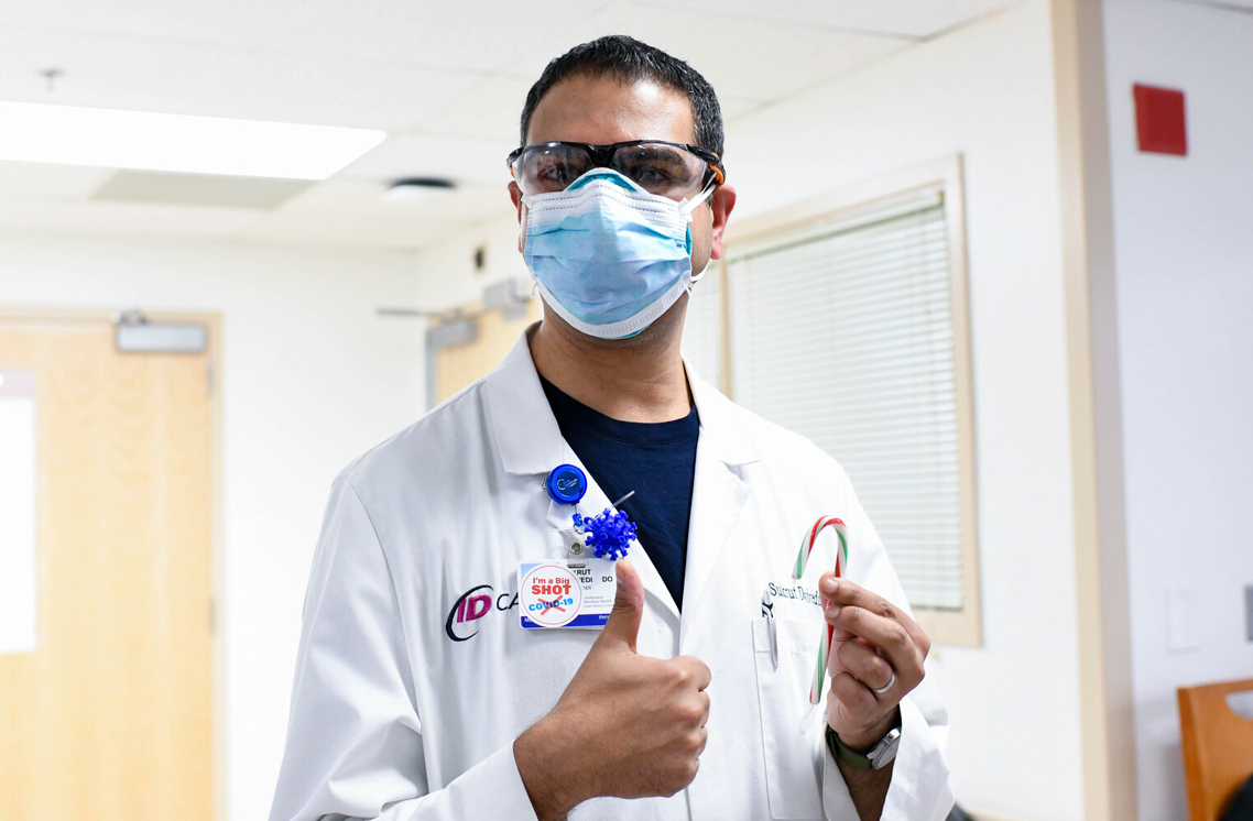 Male healthcare worker wearing a I'm a Big Shot sticker.