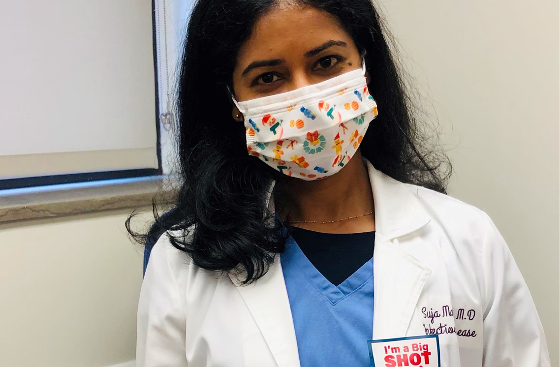 Female healthcare worker wearing a I'm a Big Shot sticker.