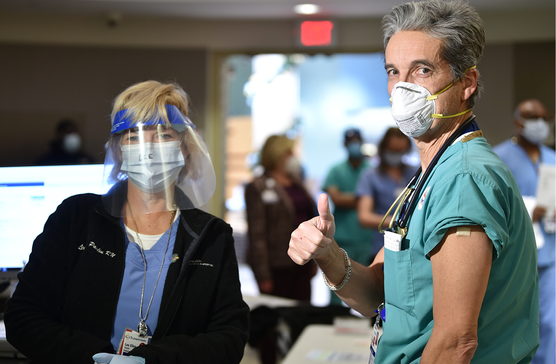 Female and male healthcare workers posing.