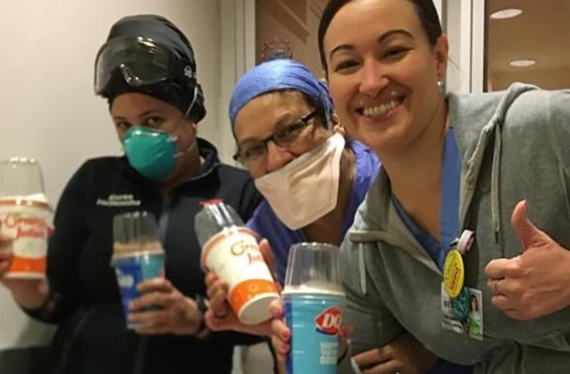 Three female healthcare workers posing.