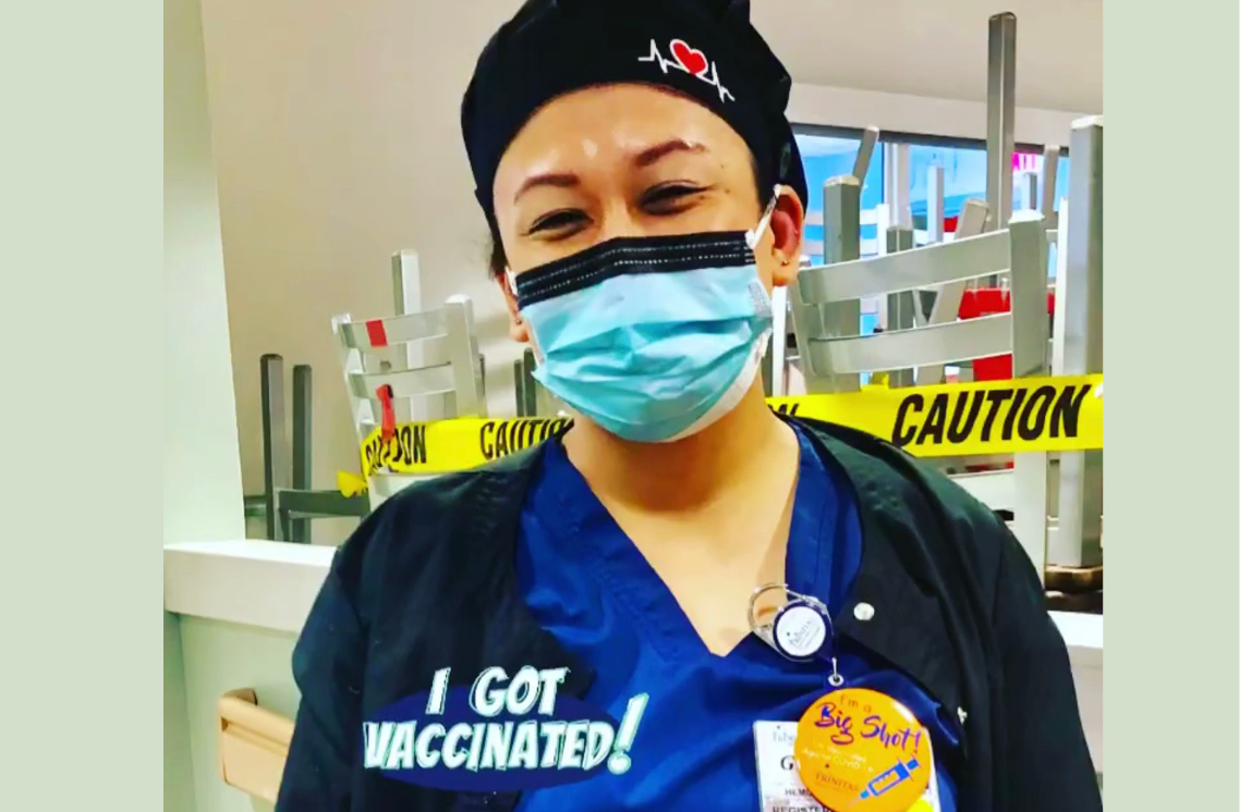 Female healthcare worker wearing a I'm a Big Shot sticker.