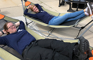Two students on a hammock.