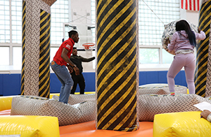 Students playing in a blow up jungle gym.