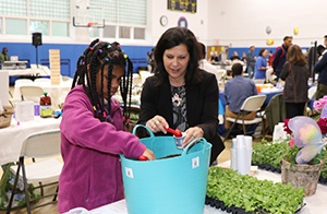 Student and teacher working with plants.