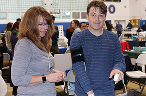 Student wearing blood pressure measuring cuff.